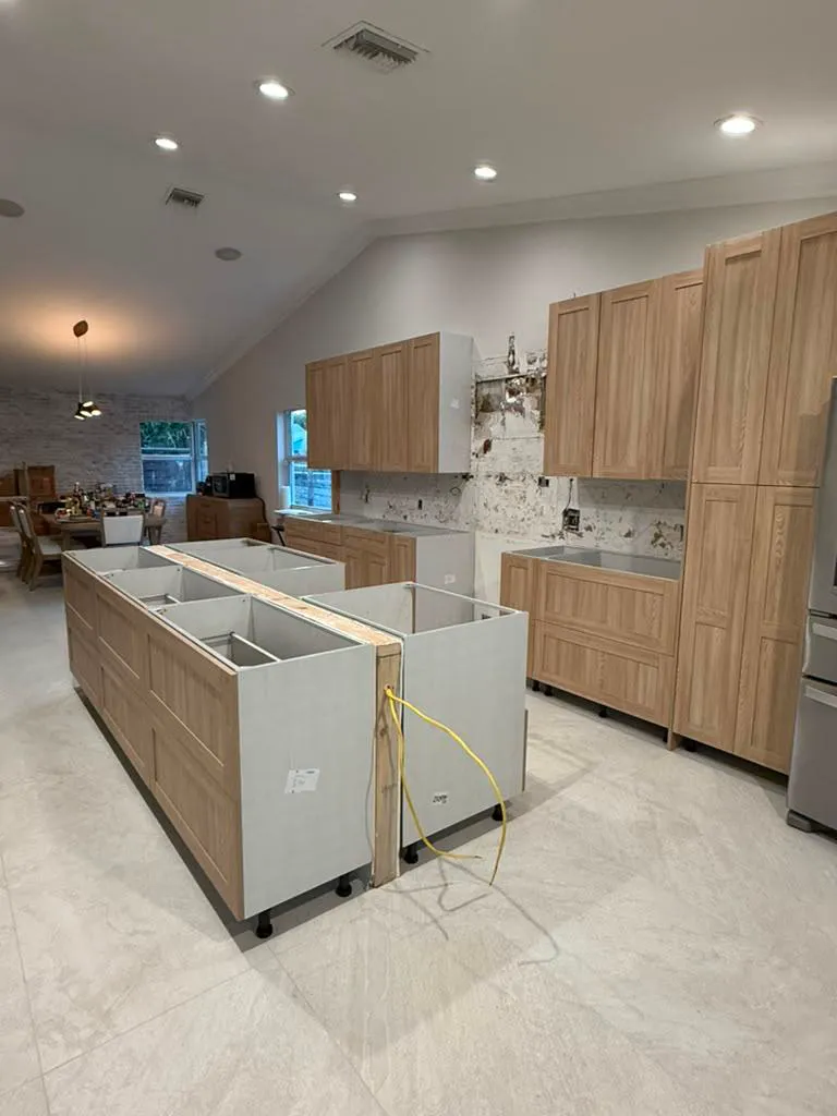 Oak kitchen cabinets and island bases set in place before countertops