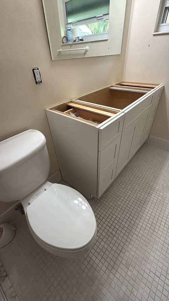 Bathroom vanity cabinet set in place during installation