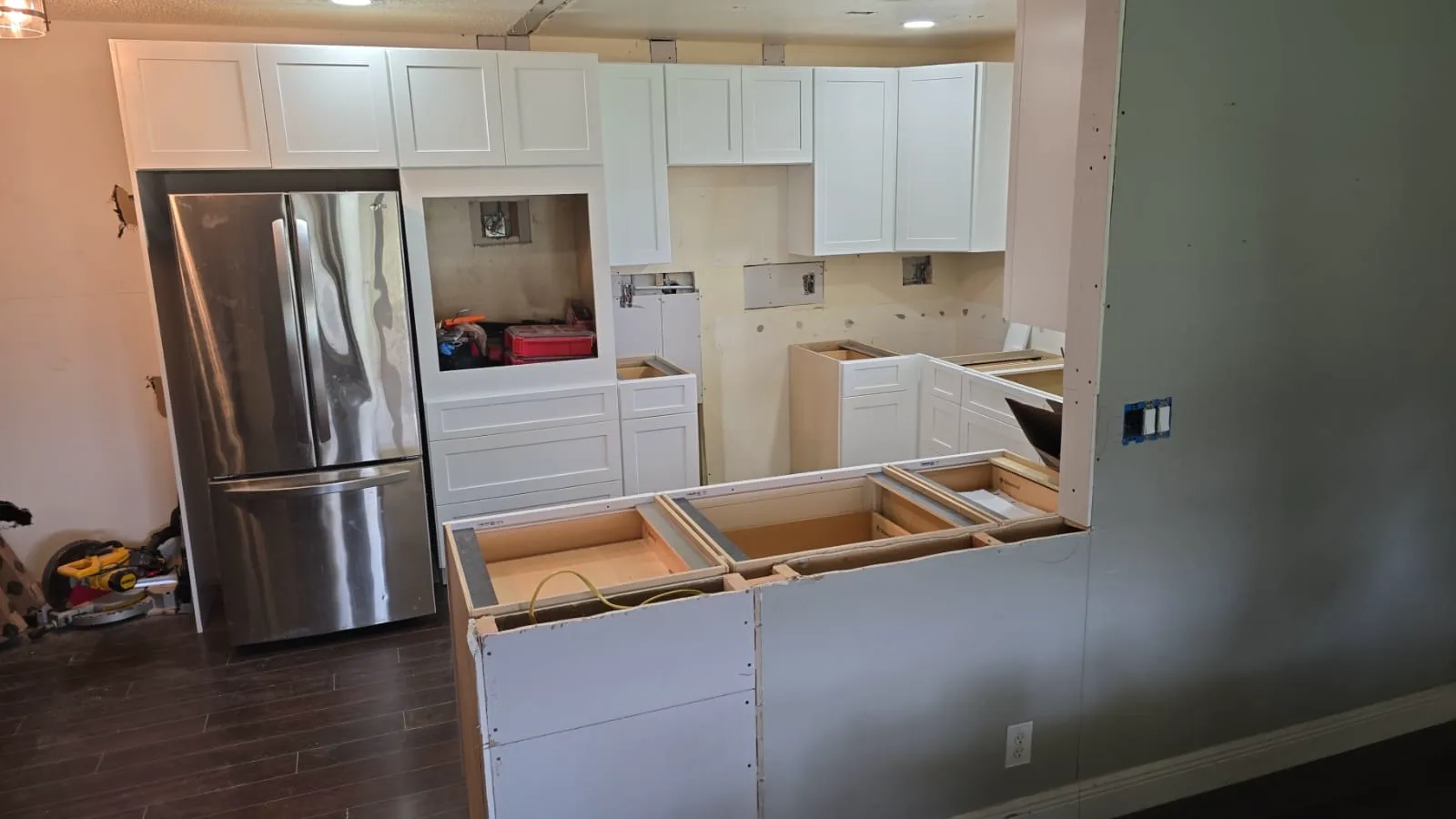 White shaker cabinets and island bases installed before countertop templating