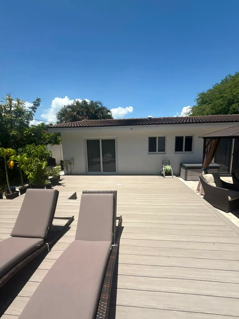Completed backyard composite deck with lounge seating and gazebo